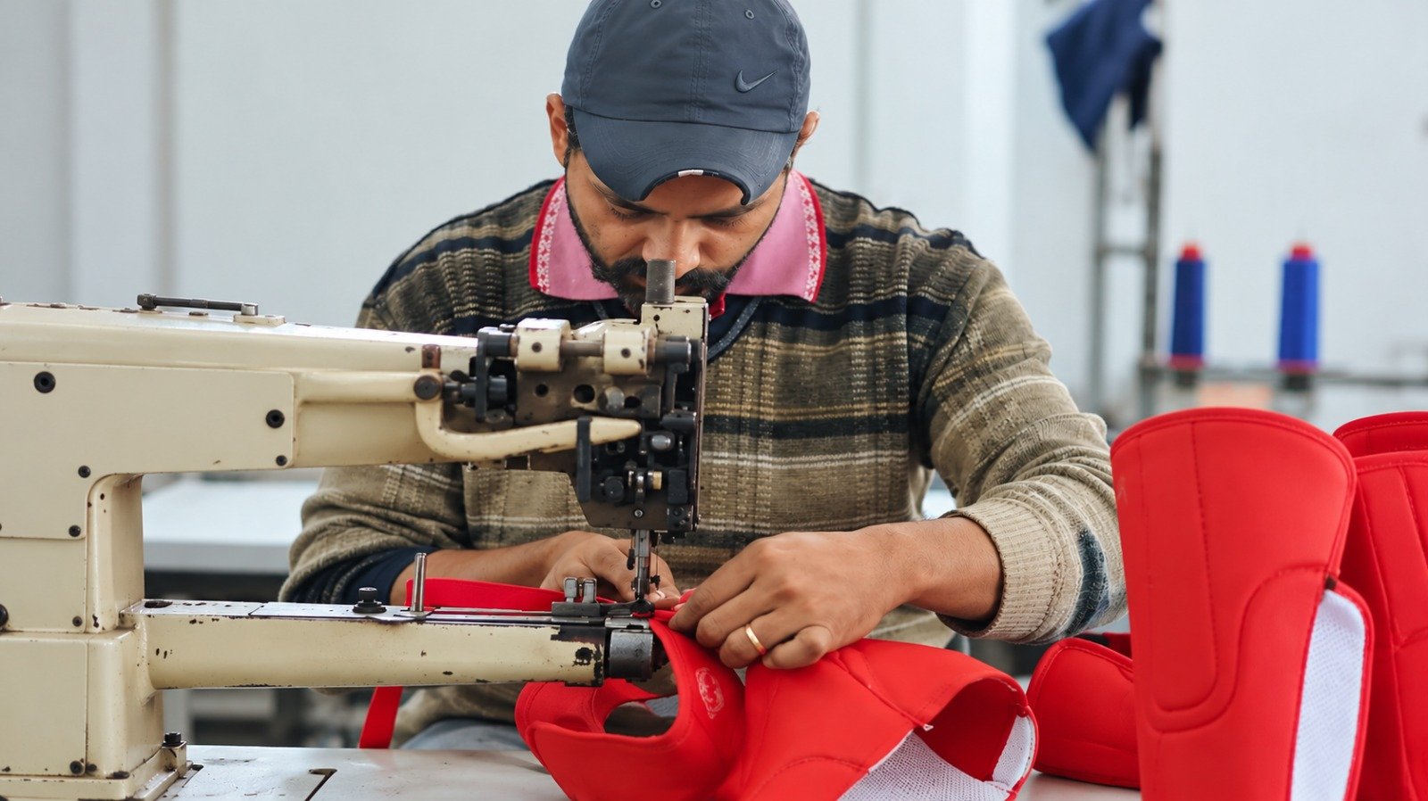 Stitching and assembly of sports protective equipment